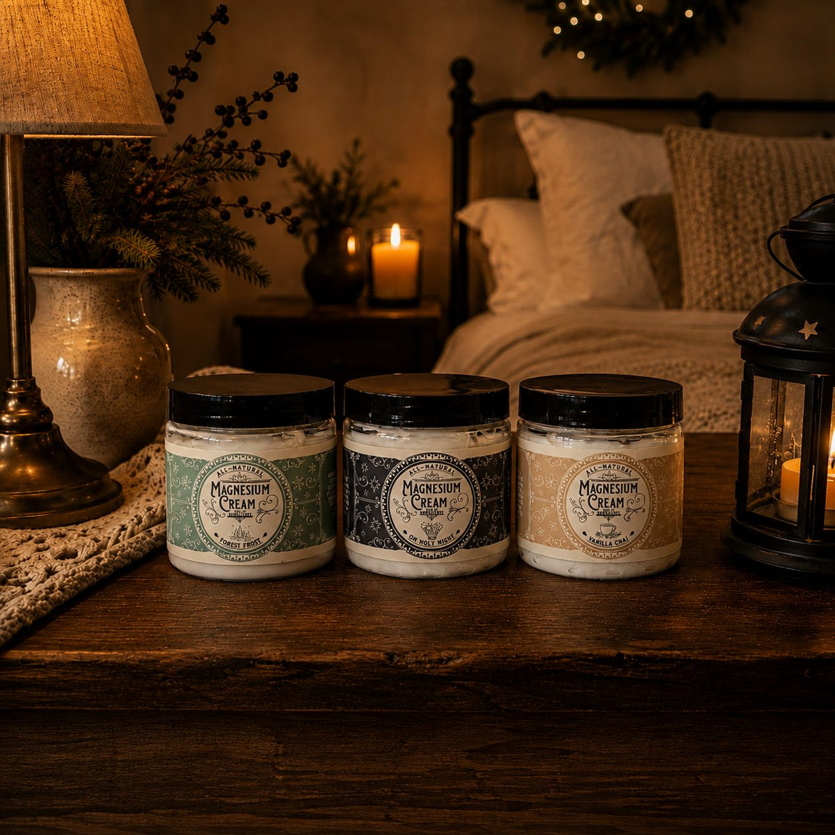 Three holiday magnesium creams, Forest Frost, Oh Holy Night and Vanilla Chai, on a cozy bedside table