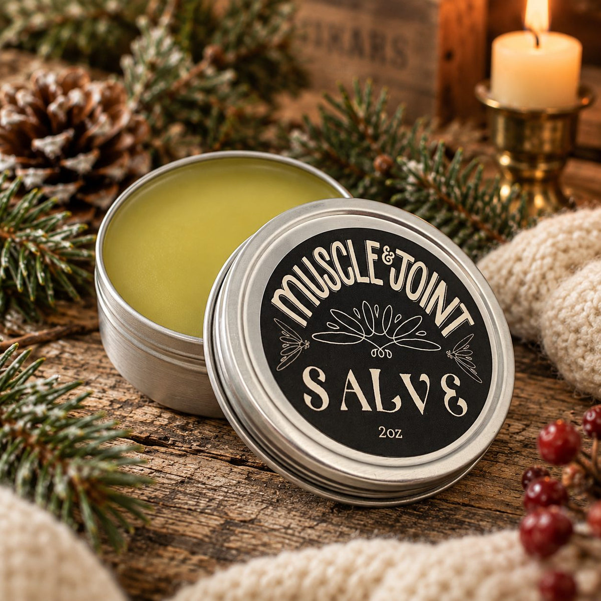 Open tin of The Humble Life Muscle & Joint Salve with pine and candlelight